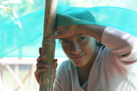 Changing a mosquito net at the dining hall of NPH Peru
