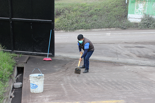 A staff member cleans ash at NPH