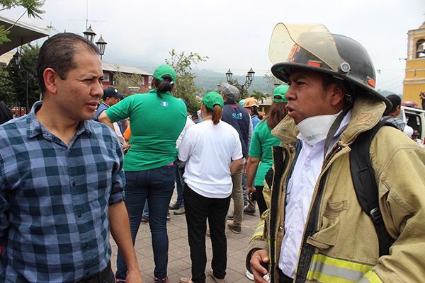 Orlando Ramos, National Director of NPH Guatemala, and Tio Eliseo, a volunteer firefighter, visit Alotenango, a town devastated by the disaster